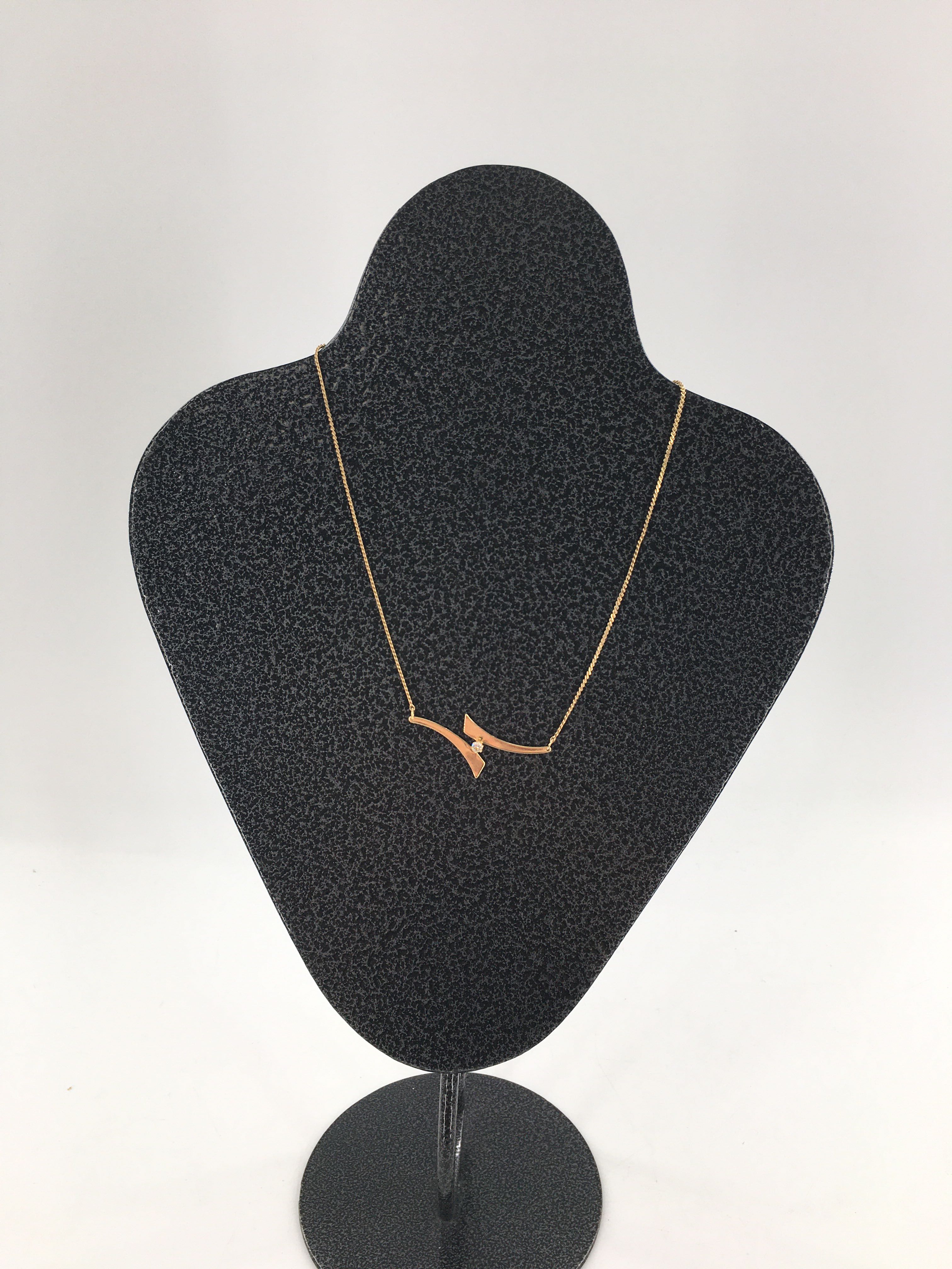 8" gold tone swoosh pendant w/ center rhinestone