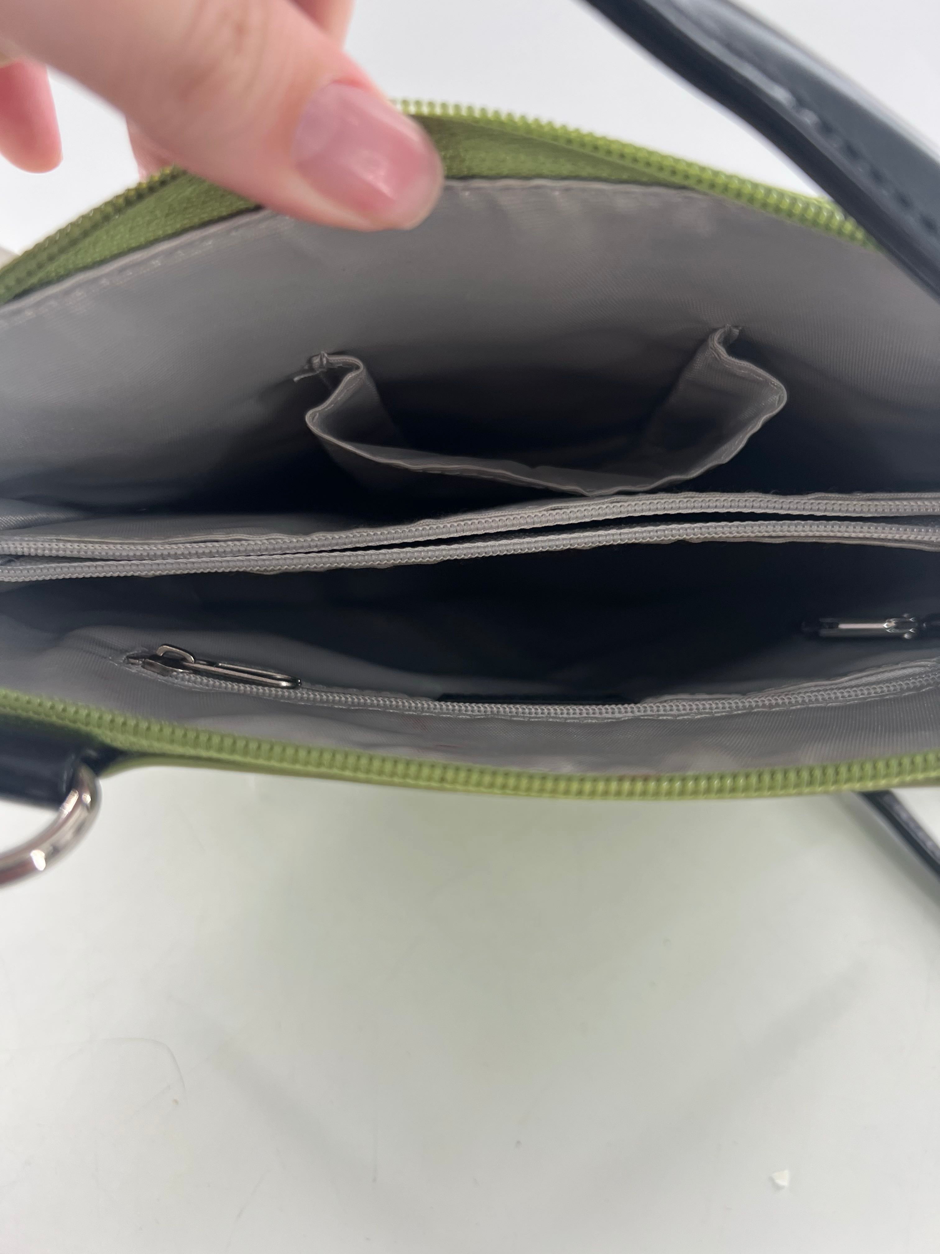patent zip around shoulder bag w/ prominent front pocket