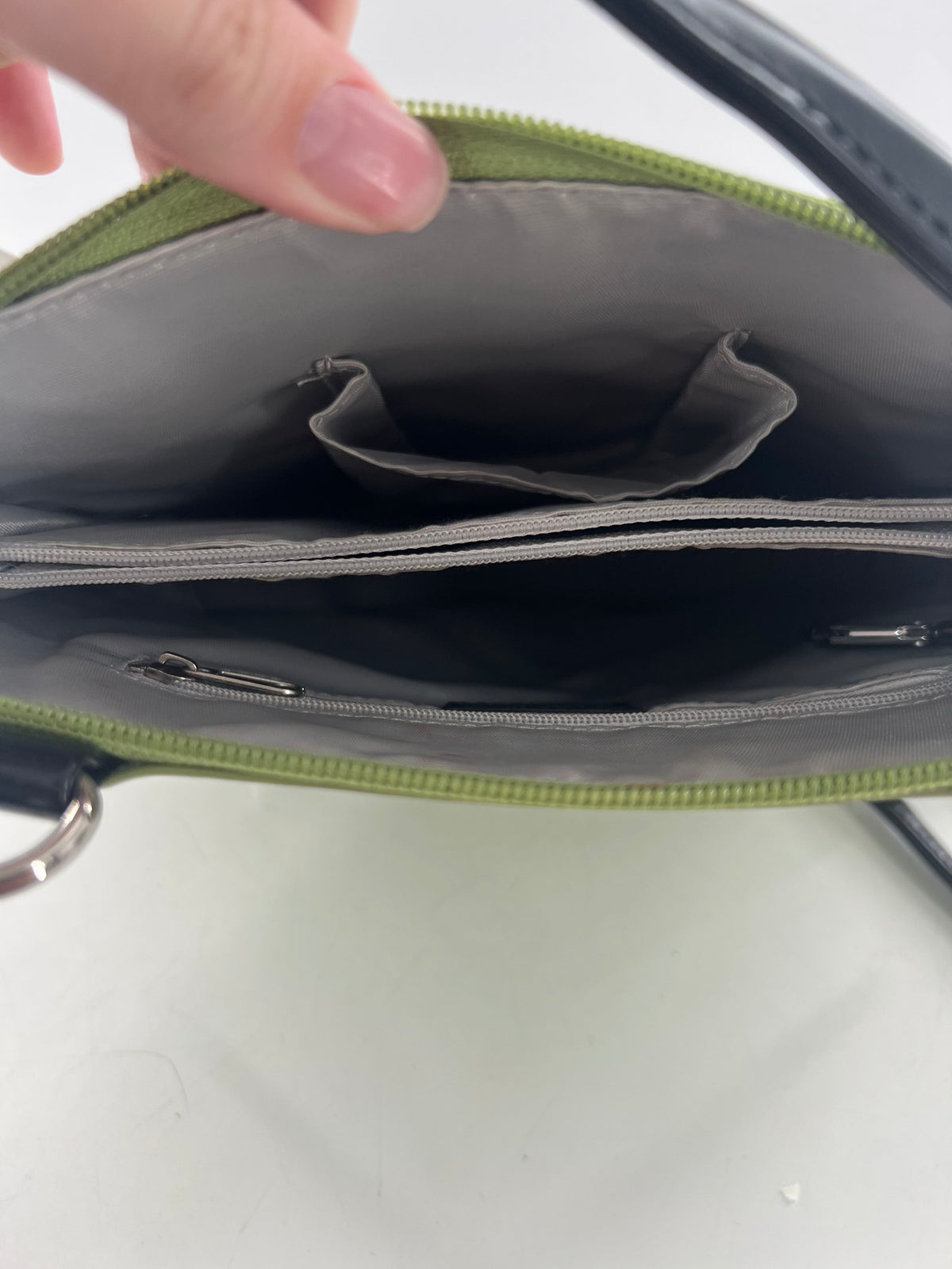 patent zip around shoulder bag w/ prominent front pocket