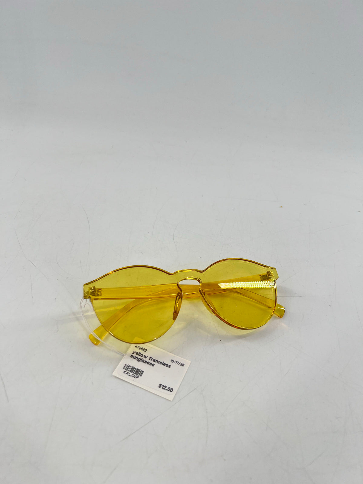 yellow frameless sunglasses