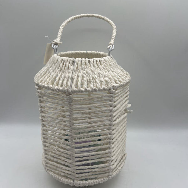 White wicker lantern with candle