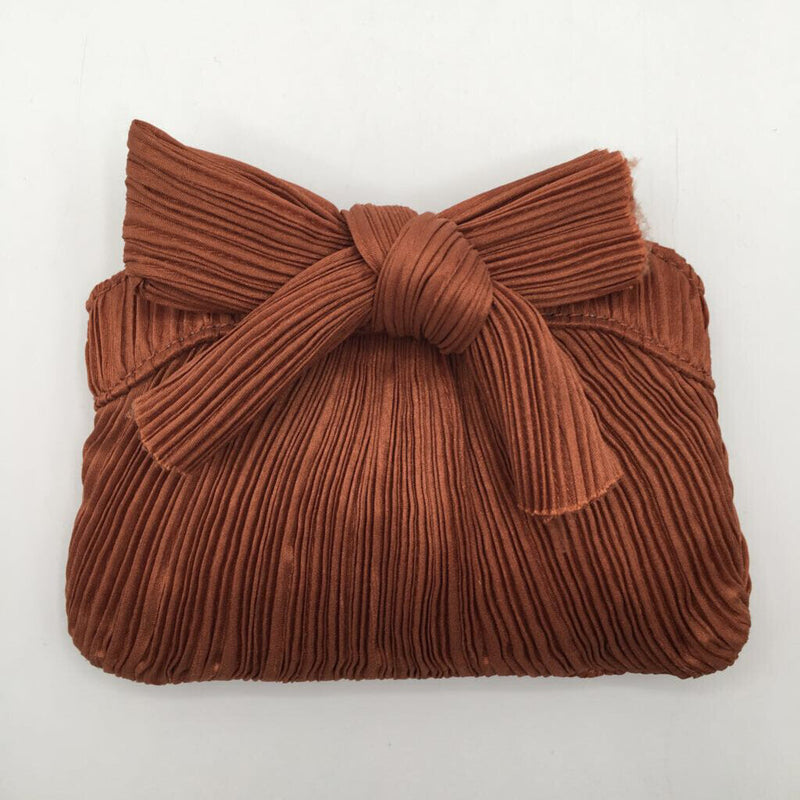 rayne pleated bow clutch