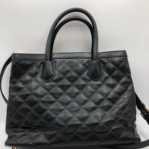 footed quilted turn lock satchel