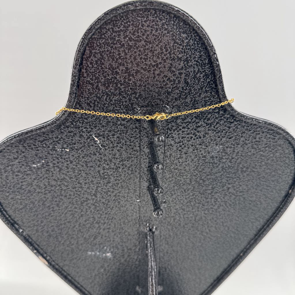 10" gold necklace w/ grey stone cross
