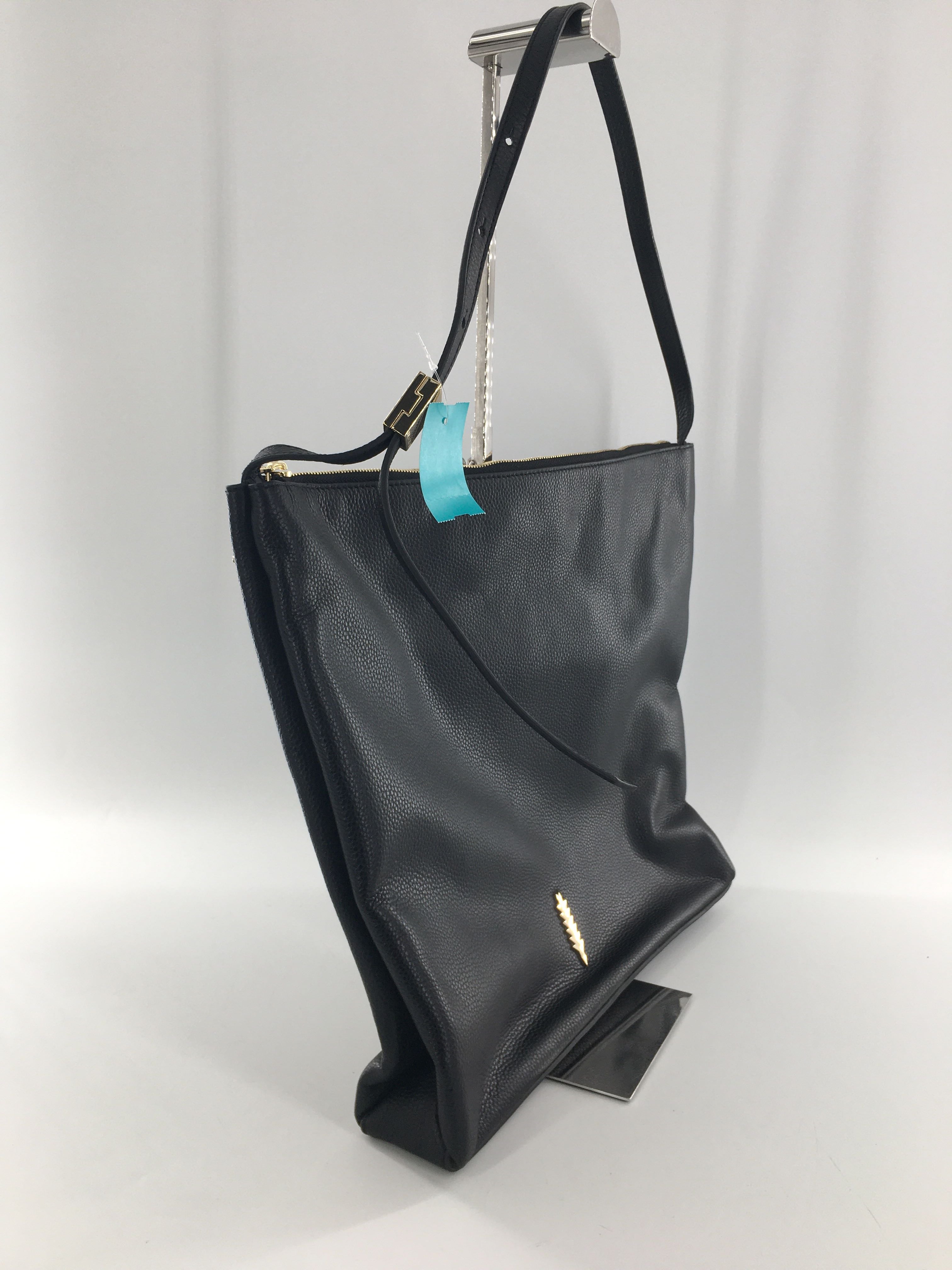 leather adjustable strap crossbody w/ gold tone feather emblem