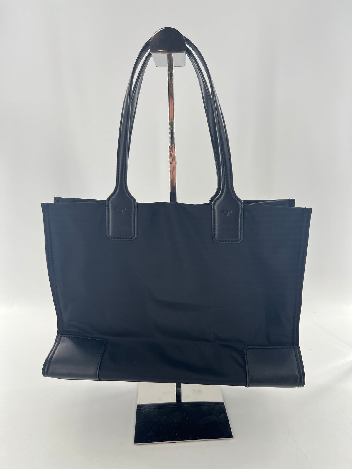 circular studded logo magnetic closure tote