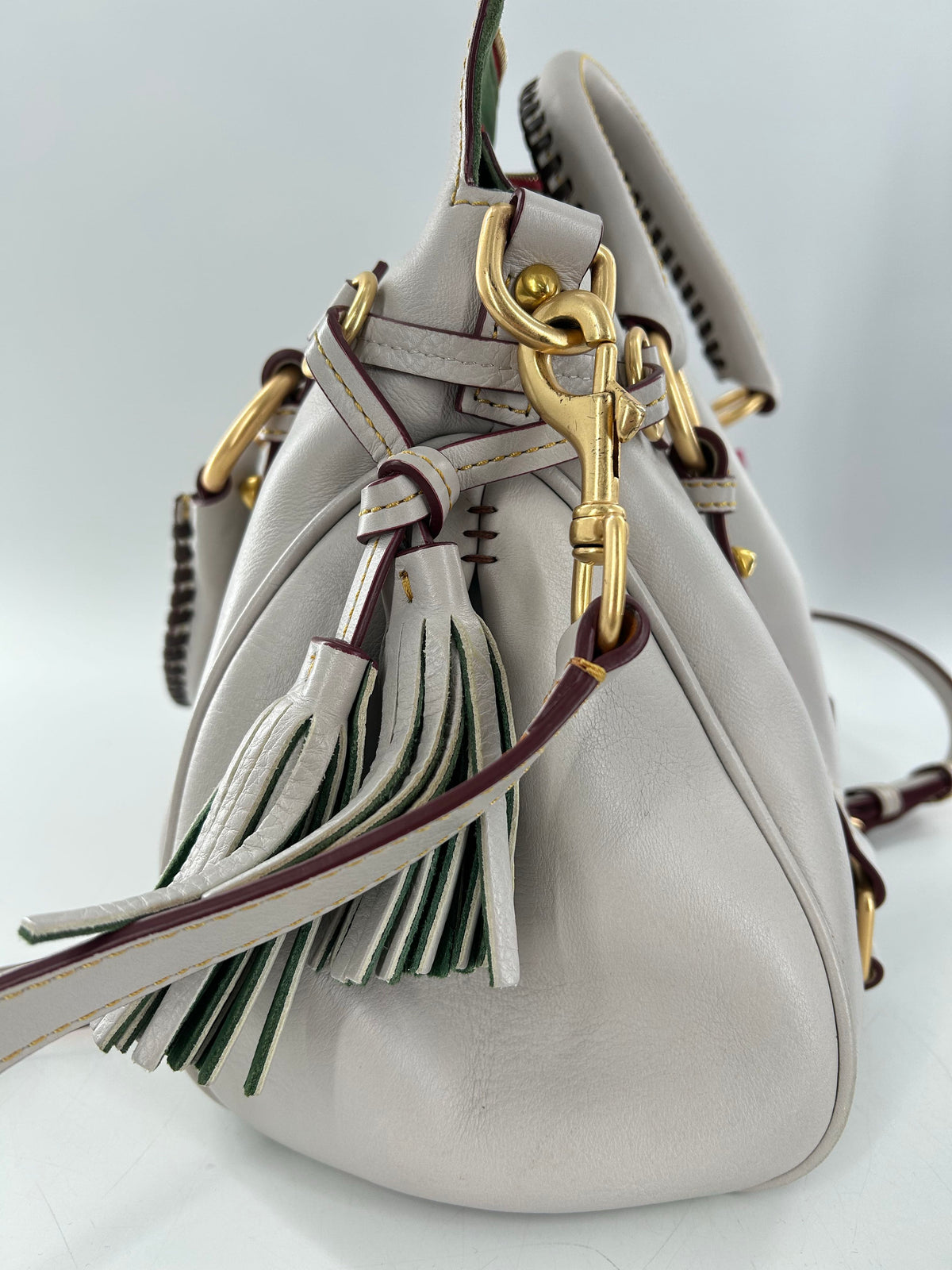 whipstitch handle tassel satchel