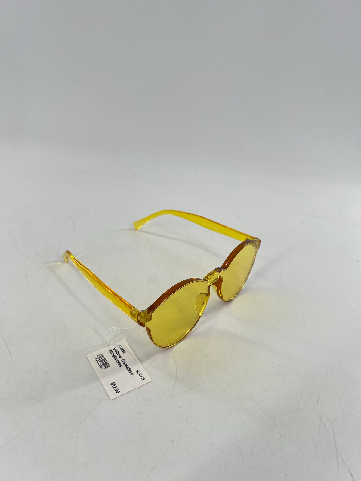 yellow frameless sunglasses